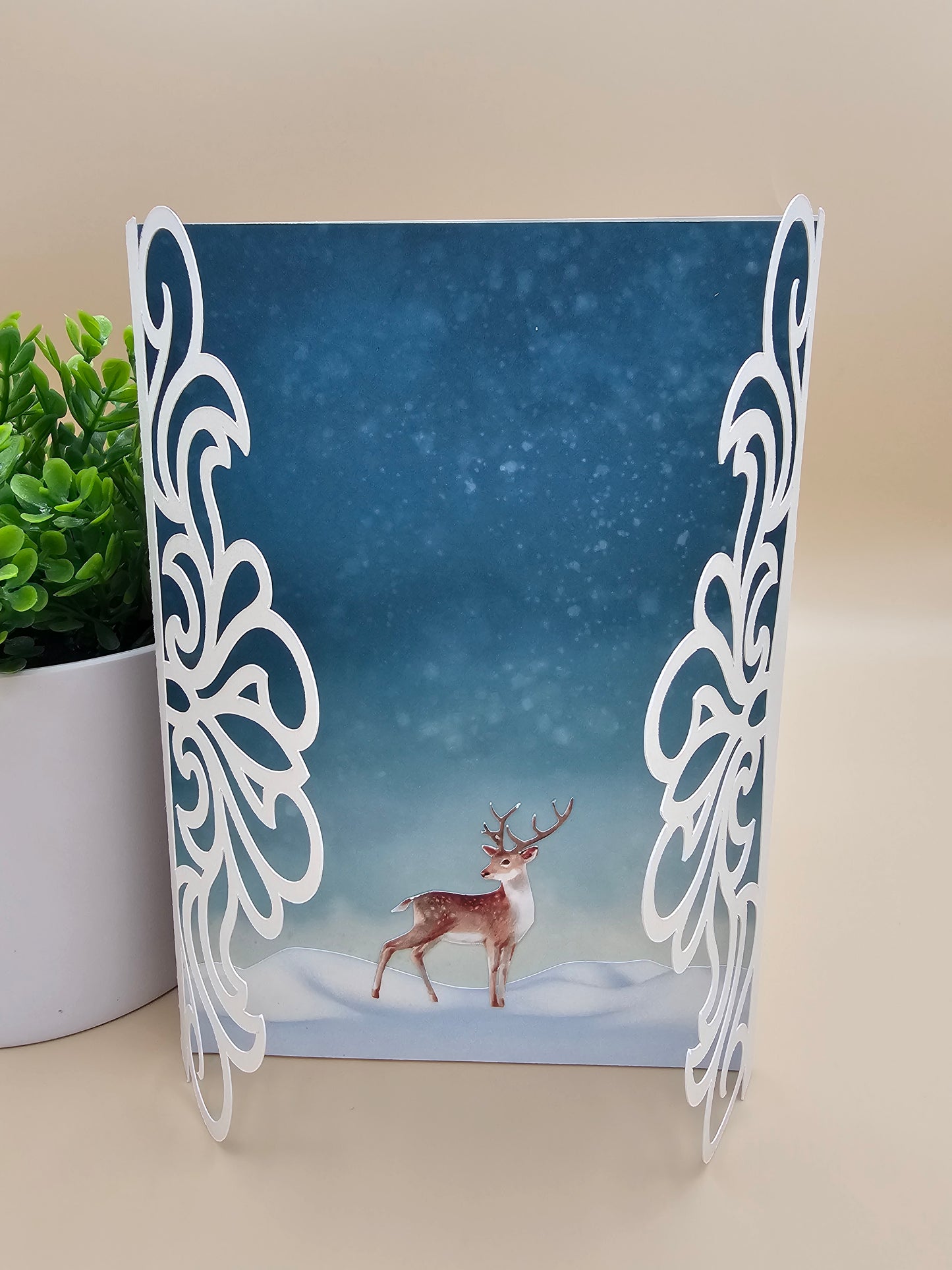 A greeting card with a wintery nature scene featuring a solitary deer, the inside reads "Wishing you peace and comfort in this time of profound sorrow."